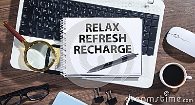 Relax, Refresh, Recharge on notepad Stock Photo