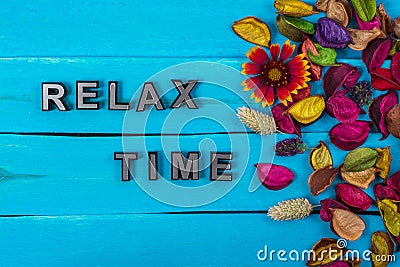 Relax time text on blue wood with flower Stock Photo