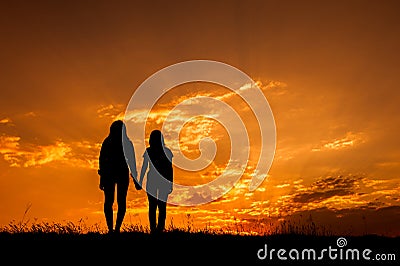 Relax women standing and sunset silhouette Stock Photo