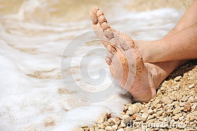 Relaxation on beach, detail of male feet Stock Photo