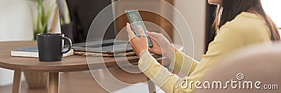 Relaxation concept, Young woman check online sales income on phone while sitting to relax on floor Stock Photo