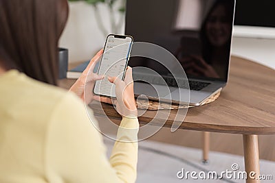 Relaxation concept, Young woman check online sales income on phone while sitting to relax on floor Stock Photo