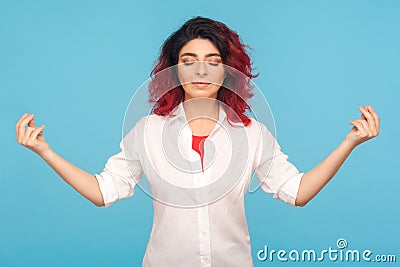 Relaxation and harmony. Portrait of peaceful hipster woman with fancy red hair keeping hands in mudra gesture Stock Photo