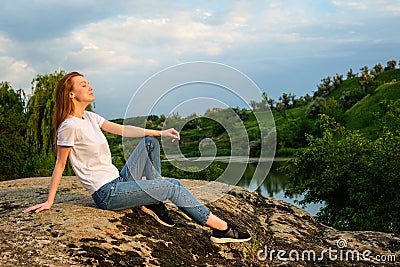 Relaxation, meditation mental health concept. National Relaxation Day. Red-haired woman meditates and relaxes in nature Stock Photo