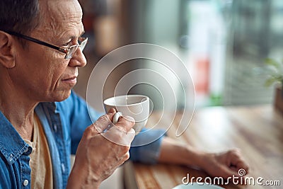 Relaxed aged man sitting in cafe with coffee Stock Photo