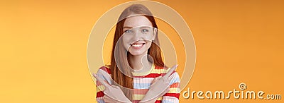 Relaxed carefree confident young helpful redhead girl showing you choices pointing crossed arms left right different Stock Photo