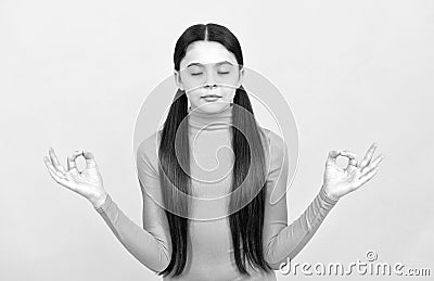 relaxed child with long hair meditating on yellow background, yoga Stock Photo