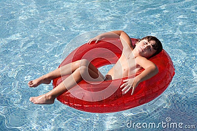 Relaxed child in the pool Stock Photo