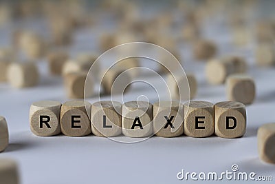 Relaxed - cube with letters, sign with wooden cubes Stock Photo