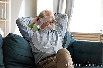 Relaxed happy mature old man enjoying free lazy weekend time. Stock Photo