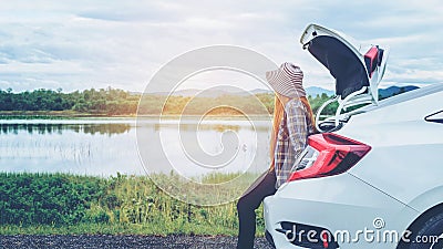 Relaxed happy woman traveler on summer roadtrip vacation on hatchback car Stock Photo