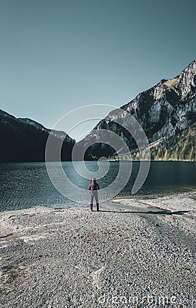 Relaxed hiker enjoys stunning view on mountain and lake in austria Stock Photo