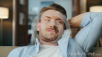 Relaxed man chilling sofa evening home closeup. Carefree gentleman sitting couch Stock Photo