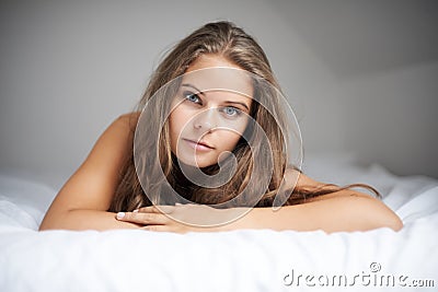 Relaxed and naturally beautiful. Portrait of a beautiful woman lying in her bed in her lingerie. Stock Photo