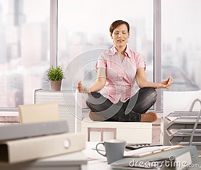 Relaxed office worker doing yoga Stock Photo