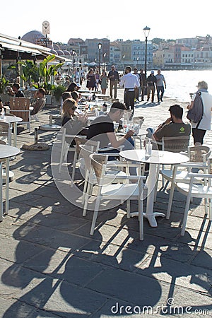 Relaxed pavement cafe at the charming, historic Venetian harbor at Hania, Greece Editorial Stock Photo