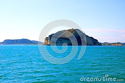 View from the Gulf of Naples at a rocky outcrop and a few boats Stock Photo