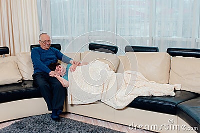 Relaxed woman asleep on husband& x27;s lap. free time, weekend together, senior couple date concept. Stock Photo