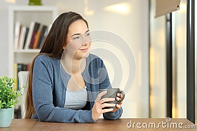 Relaxed woman contemplating at home Stock Photo