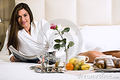 Relaxed Woman Having Breakfast in Bed Stock Photo