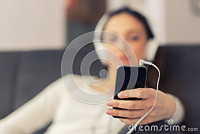 Relaxed woman listening to music in the living-room at home Stock Photo