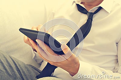 Relaxed young man using a tablet computer Stock Photo