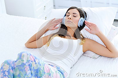 Relaxed young woman listening to music in headphones Stock Photo