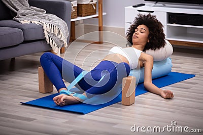 Relaxed Young Woman Doing Exercise Stock Photo