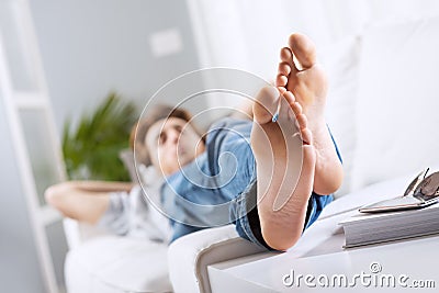 https://thumbs.dreamstime.com/x/relaxing-barefoot-young-man-sofa-living-room-feet-close-up-39559763.jpg