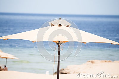 Relaxing Beach background with umbrellas and sea Stock Photo