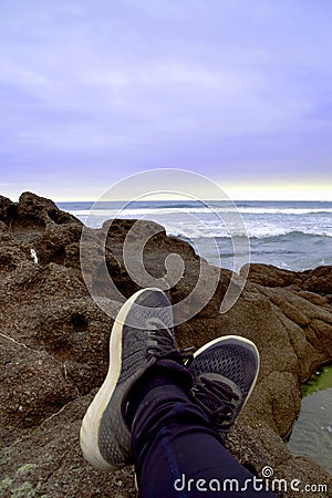 Relaxing on the cliffs while watching the sunset Stock Photo