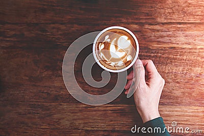 Relaxing Cozy in Cafe Concept, Female hand holding a Hot Latte C Stock Photo