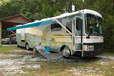 Relaxing in front of a class a motorhome Stock Photo