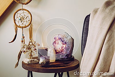 Relaxing home shrine with relaxing objects amethyst cluster geode lamp illuminated. Stock Photo