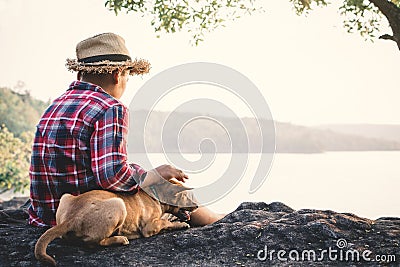 Relaxing moment Asian boy and dog in nature Stock Photo