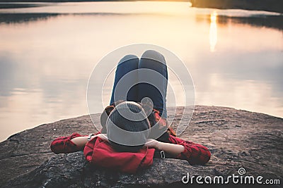 Relaxing moment Asian tourist sleeping on rock waiting for sunset Stock Photo