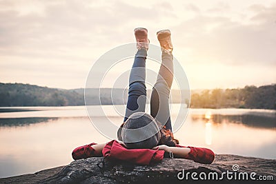 Relaxing moment Asian tourist sleeping on rock waiting for sunset Stock Photo