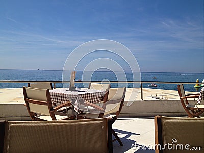 Table and chairs with sea view Editorial Stock Photo