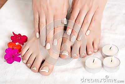 Relaxing Manicure and Pedicure: Serene Beauty with Red Flowers and Candles Stock Photo