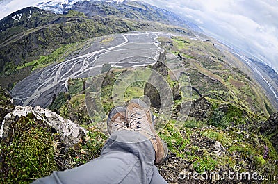 Relaxing time on a ledge of a mountain, enjoying the beautiful view valley in Thorsmork Stock Photo