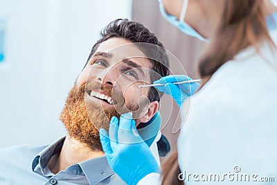 Reliable dentist using sterile instruments while cleaning the te Stock Photo