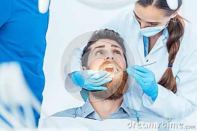 Reliable dentist using sterile instruments while cleaning the te Stock Photo