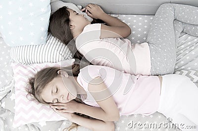 Reliable rear. healthy baby sleep. best friends. sisters in bed. sweet dreams. little girls pajama in bedroom. childhood Stock Photo