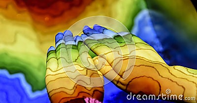 The relief of the earth is reflected in the hands of a child through different colors Stock Photo