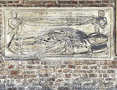 Relief of Saint Petronius on a wall of the Courtyard of Pilate in the Basilica of Saint Stephen in Bologna, Italy. Stock Photo