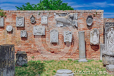 Relief sculptures on brick wall on the island of Torcello, Venice, Italy Stock Photo