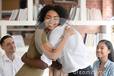 Diverse people hug show empathy at group counselling Stock Photo