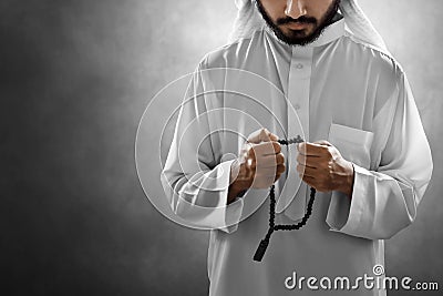 Religious arab muslim man praying with rosary bead Stock Photo
