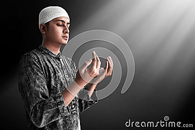 Religious asian muslim man praying Stock Photo