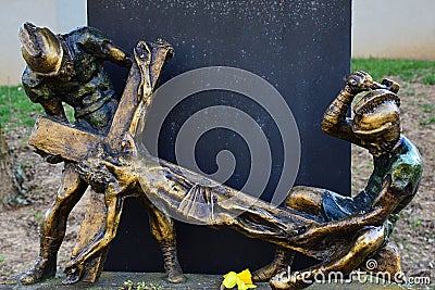 Religious bronze sculptural group of Eleventh Station Of The Cross from Way of Sorrows - Jesus is nailed on the cross. Editorial Stock Photo